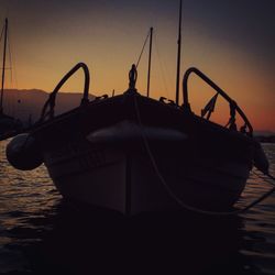 Boat moored at harbor against clear sky