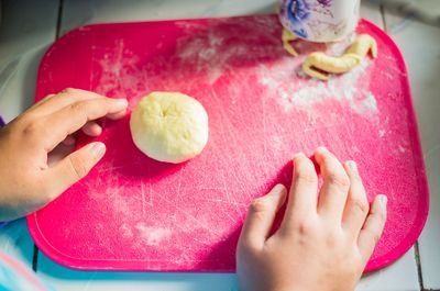 High angle view of hands and fruits on table