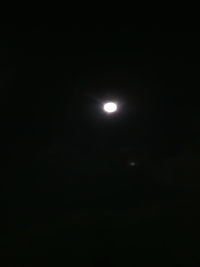 Low angle view of moon against sky at night