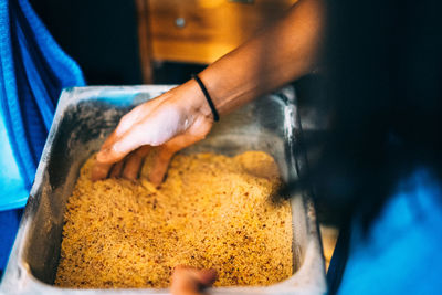 Cropped hands mixing food in container