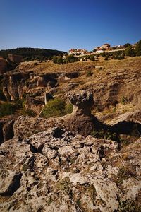 Scenic view of cliff against clear sky