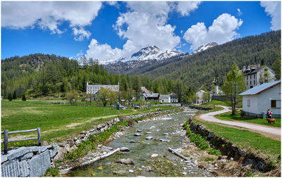 Scenic view of landscape and buildings against sky