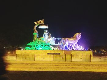 Statue of illuminated building against sky at night