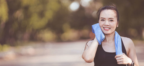 Portrait of smiling young woman standing outdoors