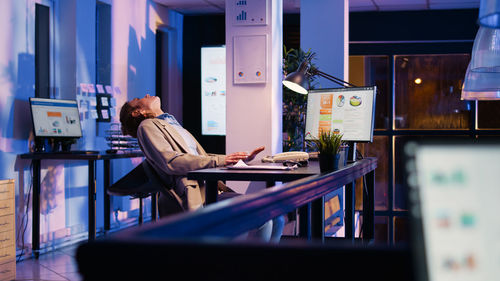 Rear view of woman sitting in cafe