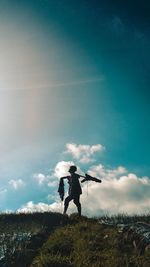 Man standing on field against sky