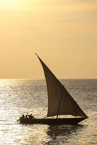 Sailboat on sea against sky during sunset