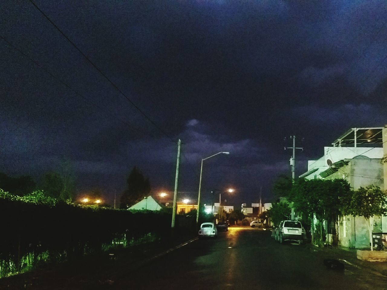 transportation, illuminated, sky, night, car, land vehicle, road, street light, mode of transport, street, cloud - sky, building exterior, cloudy, built structure, storm cloud, architecture, the way forward, weather, dusk, on the move