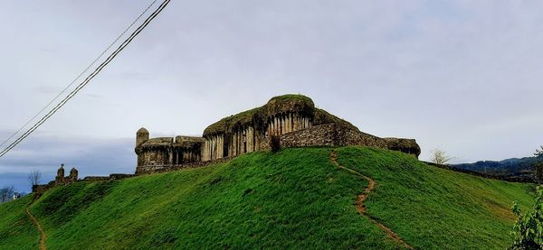 Built structure on land against sky