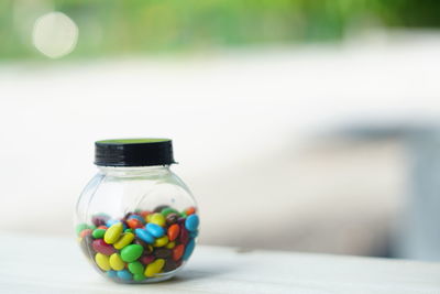 Close-up of multi colored glass on table