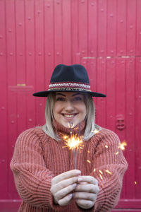 Young woman holding firework