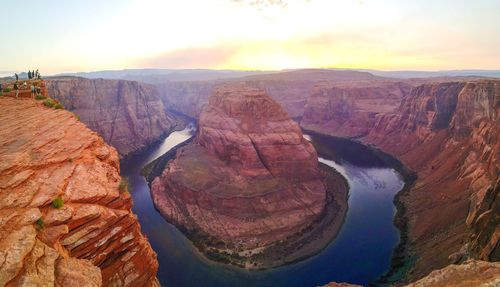 Scenic view of horseshoe bend against sky during sunset