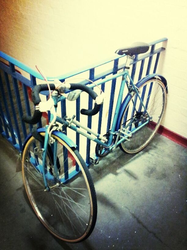 bicycle, metal, stationary, close-up, parking, parked, metallic, no people, multi colored, wall - building feature, blue, transportation, railing, land vehicle, focus on foreground, day, mode of transport, still life, in a row, wheel