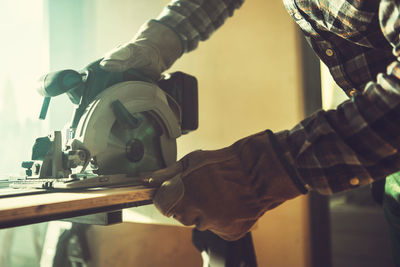 Midsection of man working in workshop