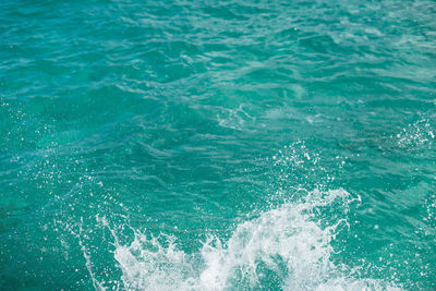 Huge splashing water in the sea from people falling into water, abstract art picture for background.