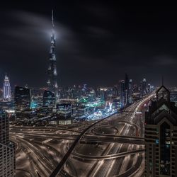 Illuminated cityscape against sky at night