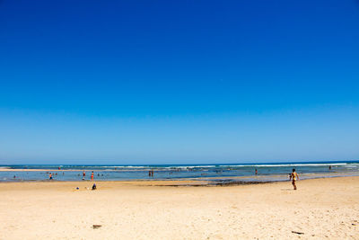 Scenic view of sea against clear blue sky