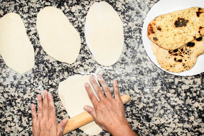 High angle view of hands on table