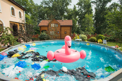 View of toy floating in swimming pool against trees