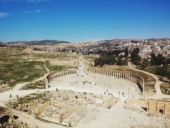 High angle view of old ruins against blue sky