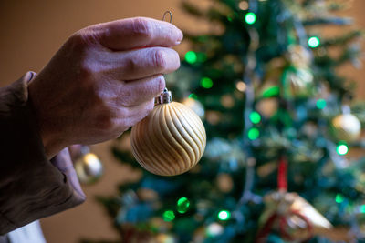 Close-up of hand holding christmas tree
