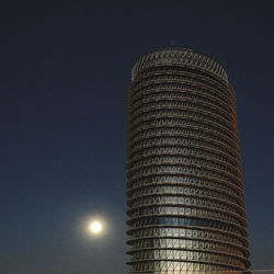 Low angle view of illuminated building against sky at night