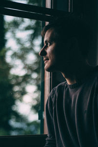 Smiling man looking towards window at home