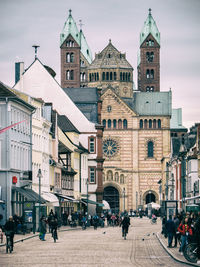 People walking on street amidst buildings in city