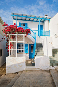 Exterior of house by building against sky