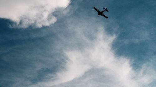 Low angle view of airplane flying in sky