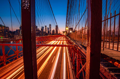 View of suspension bridge in city at night