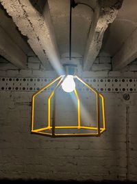 Illuminated lighting equipment hanging in tunnel