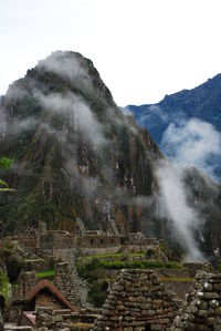 Scenic view of mountains at machu picchu in foggy weather