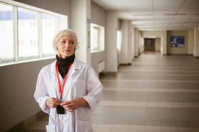 Female doctor standing in hospital lobby