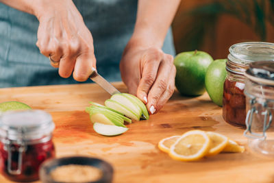 Cutting apple and lemon in the kitchen. fruit fermentation.