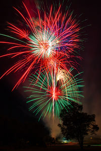 Low angle view of firework display at night