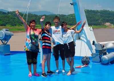 Full length of people on boats in water