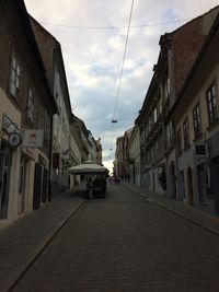 Empty alley amidst buildings in city