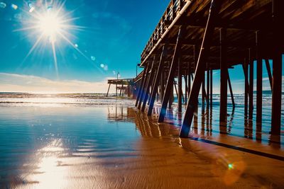 Pier over sea against blue sky