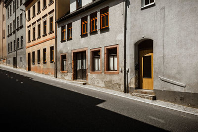 Road by building on sunny day