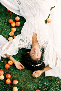 High angle view of cute baby girl lying on field