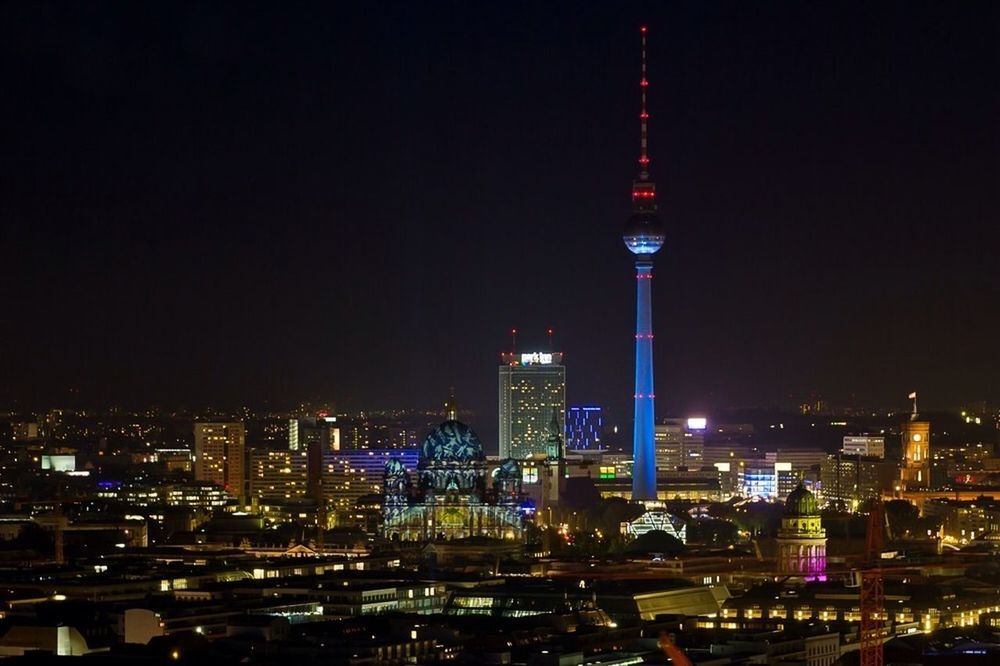 illuminated, city, building exterior, architecture, night, tower, tall - high, built structure, skyscraper, capital cities, cityscape, communications tower, international landmark, travel destinations, modern, famous place, spire, office building, tourism, travel