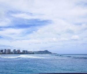 Scenic view of sea against sky in city