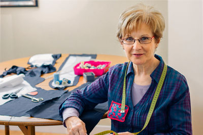 Portrait of woman by fabric on table