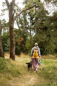 Side view of man with dog on field
