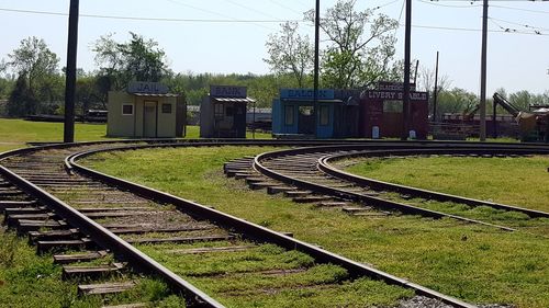 Railroad tracks on grassy field