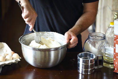 Midsection of man preparing food on table