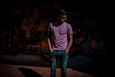 Full length portrait of young man standing at home