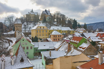 Houses in town against sky