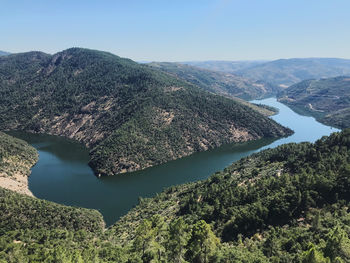 High angle view of river and mountains against sky